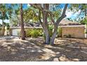 House with brick facade, mature trees, and a spacious front yard at 4346 Marine Pkwy, New Port Richey, FL 34652