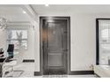 Interior entryway with dark door and view into dining area at 4408 W Minnehaha St, Tampa, FL 33614