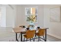 Dining area with a wood table, four chairs, and natural light at 5226 Golf Links Blvd, Zephyrhills, FL 33541