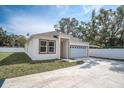 Charming single-Gathering home with a well-manicured lawn, driveway, and white picket fence at 5331 71St N Way, St Petersburg, FL 33709