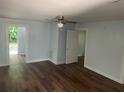 Living room with hardwood floors and ceiling fan at 8004 N 11Th St, Tampa, FL 33604