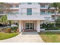 Inviting building entrance with well-manicured landscaping creating a serene and welcoming ambiance at 8040 Sailboat Key S Blvd # 304, St Pete Beach, FL 33707