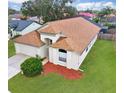 Expansive view of a well-maintained single-story home with a large roof, lush lawn, and mature trees at 814 Tuscanny St, Brandon, FL 33511