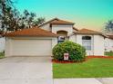 Attractive single-story home features a manicured lawn, trimmed shrubbery, and a convenient two-car garage at 814 Tuscanny St, Brandon, FL 33511