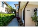 Inviting exterior of this townhouse featuring desert landscaping and a well-lit walkway at 868 Date Palm Ln, St Petersburg, FL 33707