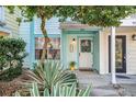 Light blue townhouse with white door and landscaping at 949 Hamilton Ct, Palm Harbor, FL 34683