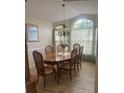 Formal dining room with wood table, chairs, and large windows at 11425 Billingham Blvd, Spring Hill, FL 34609