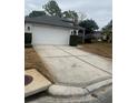 Front view of a single-story house with driveway and landscaping at 11425 Billingham Blvd, Spring Hill, FL 34609