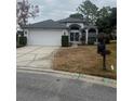 House exterior featuring a two-car garage and neat landscaping at 11425 Billingham Blvd, Spring Hill, FL 34609