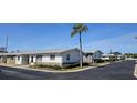 Neighborhood street showcasing well-maintained villa-style homes and lush landscaping under a clear blue sky at 12400 Park Blvd # 417, Seminole, FL 33772