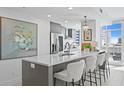 Modern kitchen island with white countertops and gray cabinetry at 145 2Nd S Ave # 523, St Petersburg, FL 33701