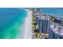 Expansive aerial view of beachfront condos and the turquoise waters of the ocean at 1540 Gulf Blvd # 1705, Clearwater, FL 33767