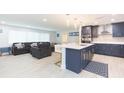 Modern kitchen with blue cabinets, white quartz island, and stainless steel appliances at 1613 Druid E Rd, Clearwater, FL 33756