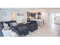 Open living area with dark gray sectional sofa and kitchen island view at 1613 Druid E Rd, Clearwater, FL 33756