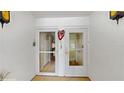 White entryway with two doors leading into the condo at 1655 S Highland Ave # D238, Clearwater, FL 33756