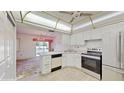 Bright kitchen with white cabinets and stainless steel appliances at 1655 S Highland Ave # D238, Clearwater, FL 33756
