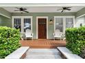 Inviting front porch with wooden floors, ceiling fans, and comfortable seating at 205 W North St, Tampa, FL 33604