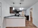 Modern kitchen with granite countertops and stainless steel appliances at 3005 E Shadowlawn Ave, Tampa, FL 33610