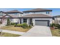 Inviting two-story home with a lush lawn and a practical two-car garage, providing comfort and convenience at 3888 Almond Brook Blvd, Land O Lakes, FL 34638