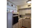 Bright kitchen with white cabinetry, built-in oven, and open shelving at 4140 55Th N St # 1115, Kenneth City, FL 33709