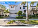 Charming two-story home with brick driveway, a two car garage, and manicured landscaping at 1021 Seagrape Dr, Ruskin, FL 33570