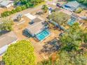 Overhead view of a screened pool and the property's expansive backyard with mature trees, providing a sense of privacy at 10261 Horizon Dr, Spring Hill, FL 34608