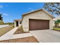 Tan house with brown garage door and walkway, nice curb appeal at 11206 Silver Fern Way, Riverview, FL 33569