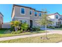 Charming two-story house with a manicured lawn and tasteful landscaping enhancing its curb appeal under a clear blue sky at 12625 Horseshoe Bend Dr, Lithia, FL 33547