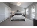 Cozy bedroom featuring high ceilings, neutral colors, and a private balcony entrance at 1442 Harbour Walk Rd, Tampa, FL 33602