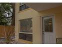 Close-up of a condo exterior highlighting a window and door under the covered patio at 145 10Th N Ave # 8, St Petersburg, FL 33701