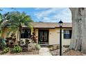 Inviting home entrance with stone accents, lush plants, and unique double doors at 1670 Monterey Dr, Clearwater, FL 33756