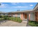 Brick ranch home front entrance with wood door at 2054 Envoy Ct, Clearwater, FL 33764