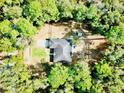 Birds-eye view of the property, highlighting the home's layout, surrounding greenery, and outdoor spaces at 26890 Hiawatha Blvd, Brooksville, FL 34601