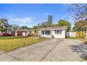 Cozy home featuring a concrete driveway and a well-maintained lawn at 2819 47Th S Ave, St Petersburg, FL 33712