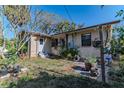 A cozy backyard featuring mature trees and lush landscaping, perfect for outdoor enjoyment at 3512 Haines N Rd, St Petersburg, FL 33704