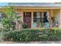 Inviting front porch with seating, plants, and a decorative storm door at 3512 Haines N Rd, St Petersburg, FL 33704