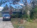 Ranch home with a carport and overgrown landscaping at 3602 Southview Ct, Brandon, FL 33511