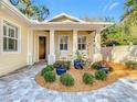 Inviting front porch featuring a cozy seating area and lovely landscaping at 415 5Th N St, Safety Harbor, FL 34695