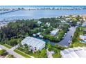 Scenic aerial view of the three-story waterfront building, nestled along a canal with boat docks and lush greenery at 4212 126Th W St # 401, Cortez, FL 34215