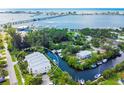 Picturesque aerial shot of waterfront condo with a serene canal, boat docks, and lush vegetation at 4212 126Th W St # 401, Cortez, FL 34215