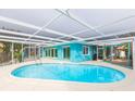 Inviting oval pool with a screened enclosure and a view of the canal at 4643 Bay Crest Dr, Tampa, FL 33615