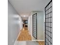 Inviting hallway showcasing hardwood floors and neutral paint, leading to various living areas and bedrooms at 4917 Puritan Cir, Tampa, FL 33617