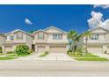 A row of well-maintained two-story homes, each featuring a two-car garage and landscaped front yards at 4925 White Sanderling Ct, Tampa, FL 33619