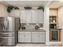 Stylish kitchen area with stainless steel appliances, granite countertops, and a convenient wine cooler for entertaining guests at 5507 Cumberland Star Ct, Lutz, FL 33558