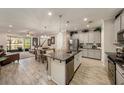 Open-concept kitchen with granite countertops, stainless steel appliances, and a seamless flow into the living and dining areas at 5507 Cumberland Star Ct, Lutz, FL 33558