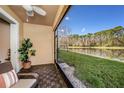 Relaxing screened lanai offering serene views of the water and lush greenery, creating a tranquil outdoor oasis at 5507 Cumberland Star Ct, Lutz, FL 33558