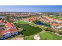 Scenic aerial shot of a residential community with golf course, ponds, and a bridge in the background at 6105 Mirada Cir, St Petersburg, FL 33715