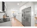 Bright kitchen with stainless steel refrigerator and modern appliances adjacent to the dining area at 6121 38Th W Ave, Bradenton, FL 34209