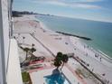 Aerial view of pristine white sand beach, palm trees, and ocean from condo at 7000 Beach Plz # 805, St Pete Beach, FL 33706