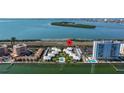 An aerial view shows waterfront condos with a pool and beach access, offering luxury coastal living at 7300 Sunshine Skyway S Ln # 202, St Petersburg, FL 33711